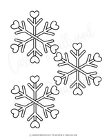 Three snowflake shapes with heart centers on a white background